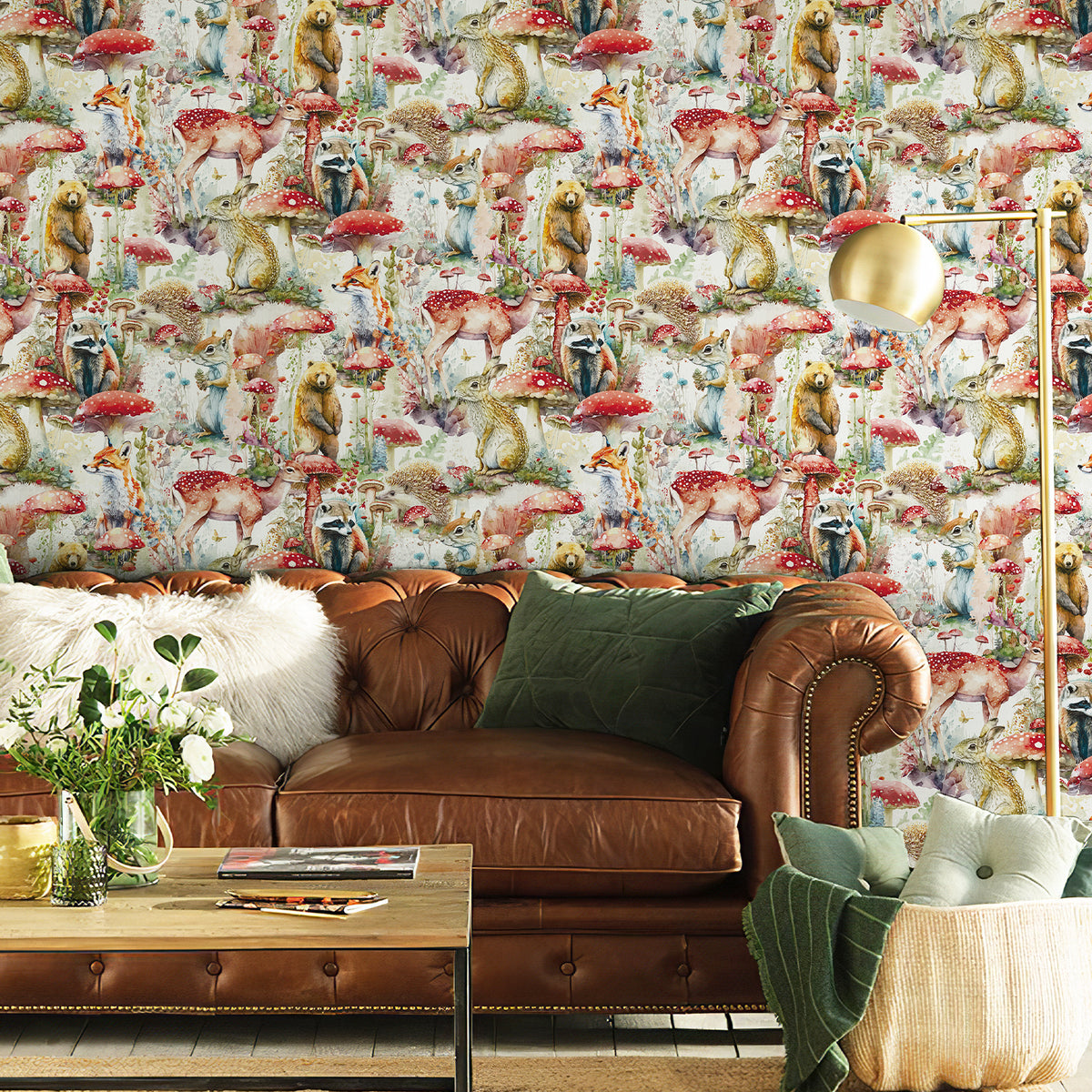 Watercolor woodland animal wallpaper serves as a striking accent wall behind a brown leather sofa, bringing rich magical forest charm to the modern living‑room.