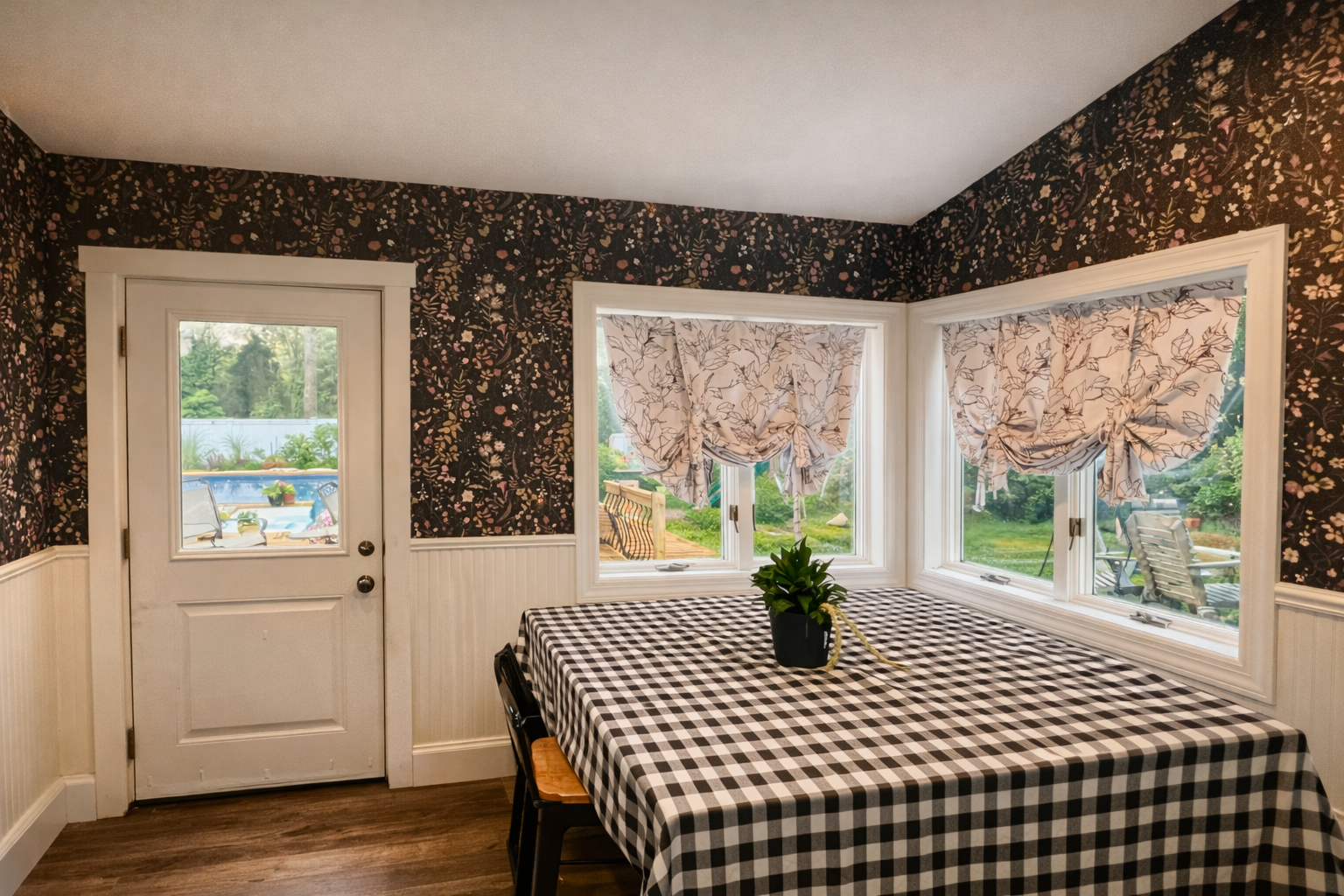 moody floral wallpaper in dining nook with white trim
